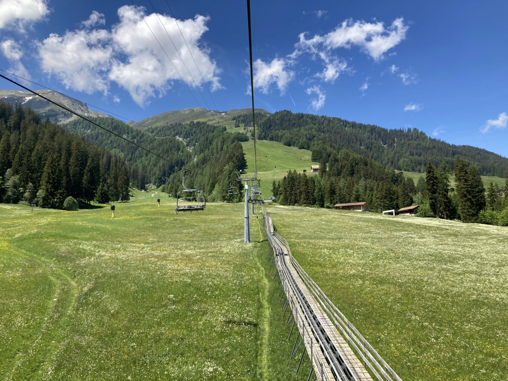 Eine berg- und Talfahrt mit der KSB Pradaschier durfte nicht fehlen. Die Wiesen sind momentan prächtig am Blühen, wie hier zu sehen ist. An der Rodelbahn übrigens über 30 Minuten Wartezeit...