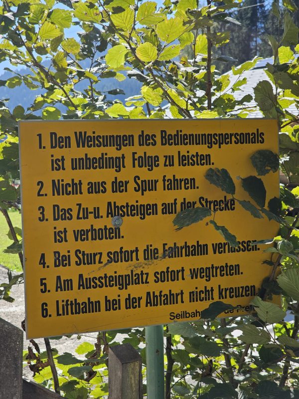 Ein Hinweisschild unweit des Parkplatzes. Man beachte den "Seilbahnbau de Pretis"-Schriftzug unten rechts.